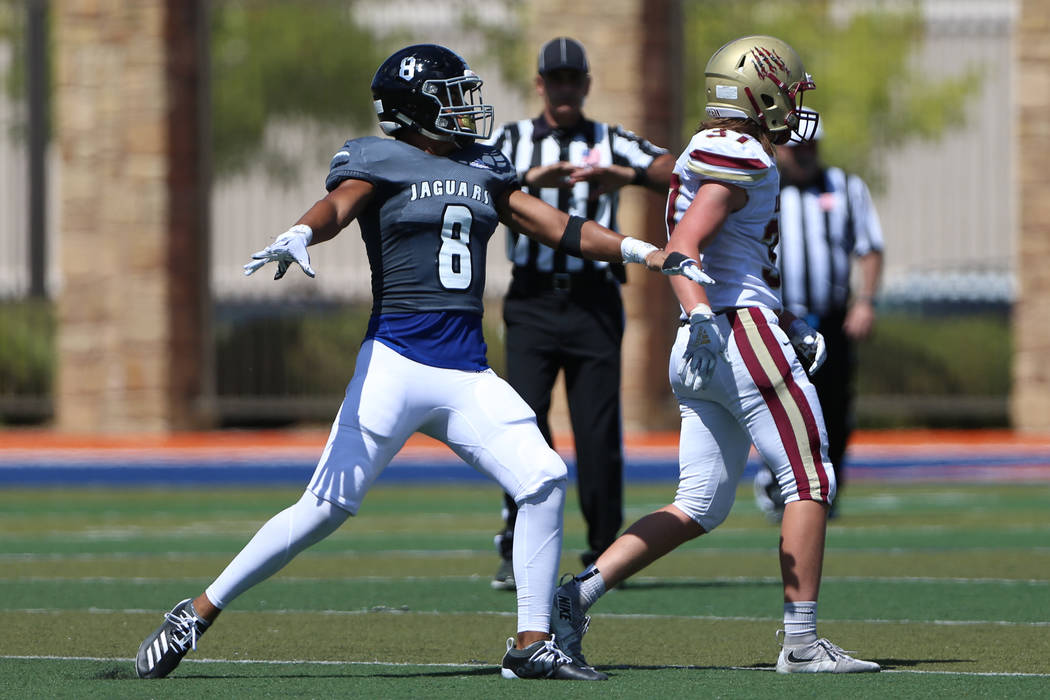 Desert Pines' William Paden iii (8) reacts after breaking a pass against Logan's Andrew Thompso ...