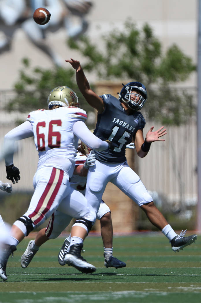 Desert Pines' Rjay Tagatases (15) throws the ball under pressure from Logan's Tennyson Hadfield ...