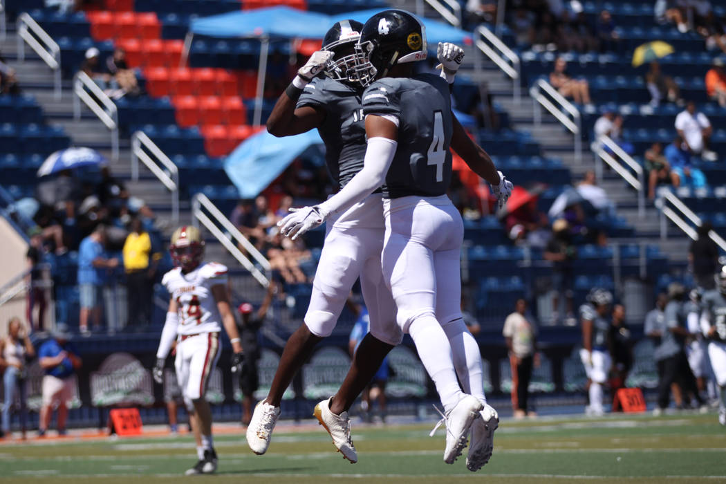 Desert Pines' Branden Thomas (4) celebrates his score with DeAndre Ware (3) against Logan durin ...