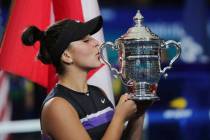 Bianca Andreescu, of Canada, kisses the championship trophy after defeating Serena Williams, of ...