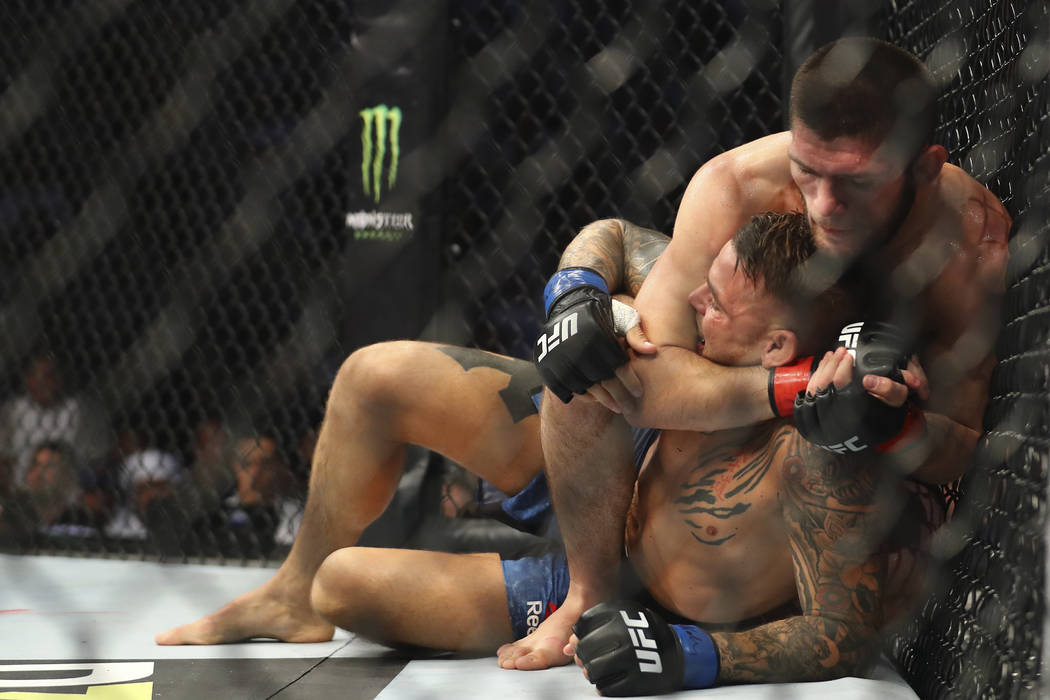 Russian UFC fighter Khabib Nurmagomedov, choke holds UFC fighter Dustin Poirier, of Lafayette, ...