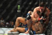 Russian UFC fighter Khabib Nurmagomedov, choke holds UFC fighter Dustin Poirier, of Lafayette, ...