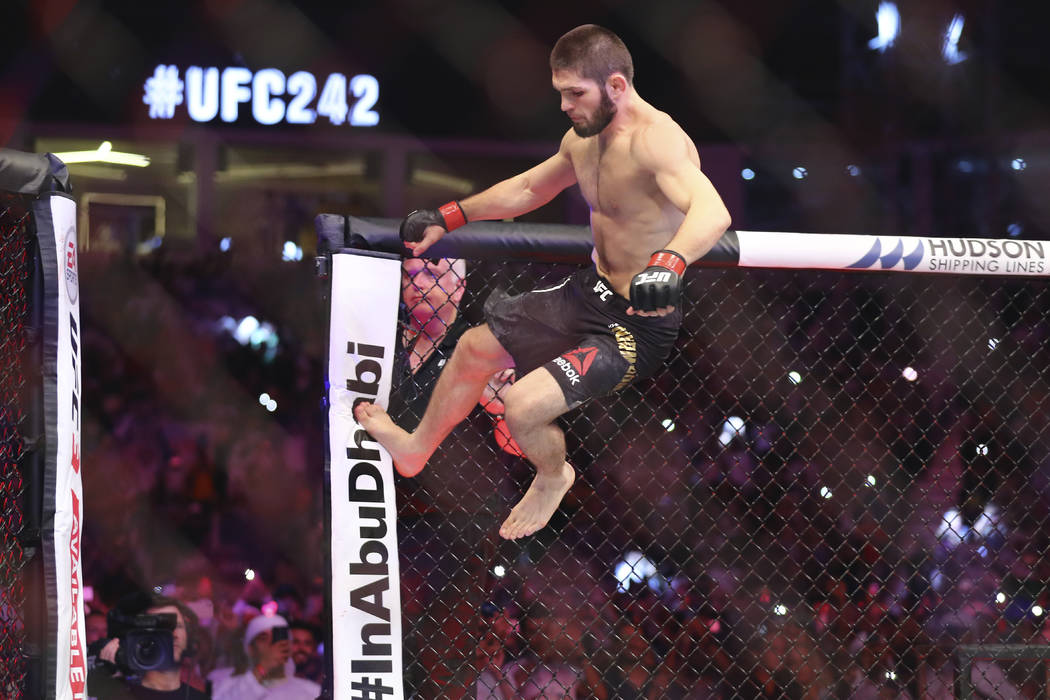 Russian UFC fighter Khabib Nurmagomedov, jumps during Lightweight title mixed martial arts bout ...