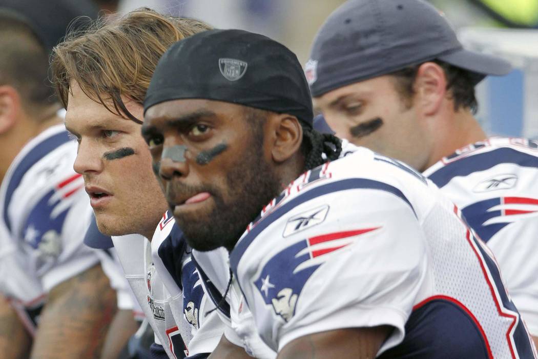 In this Sept. 12, 2010, photo, New England Patriots wide receiver Randy Moss, right, and quarte ...
