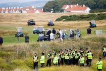 FILE--President Donald Trump plays golf under tight security at Turnberry golf club, in Turnber ...