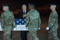 An Army carry team moves a transfer case containing the remains of Sgt. 1st Class Elis Barreto ...