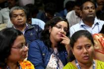 Indian Space Research Organization (ISRO) employees react after an announcement by organization ...