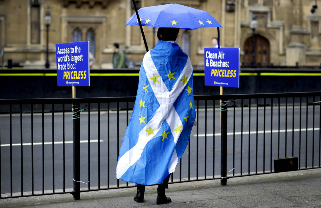 An anti-brexit campaigner stands opposite Parliament in London, Monday, Sept. 9, 2019. British ...