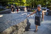 In this Thursday, Aug. 29, 2019, photo a visitor touches one of the granite slabs at the 9/11 M ...