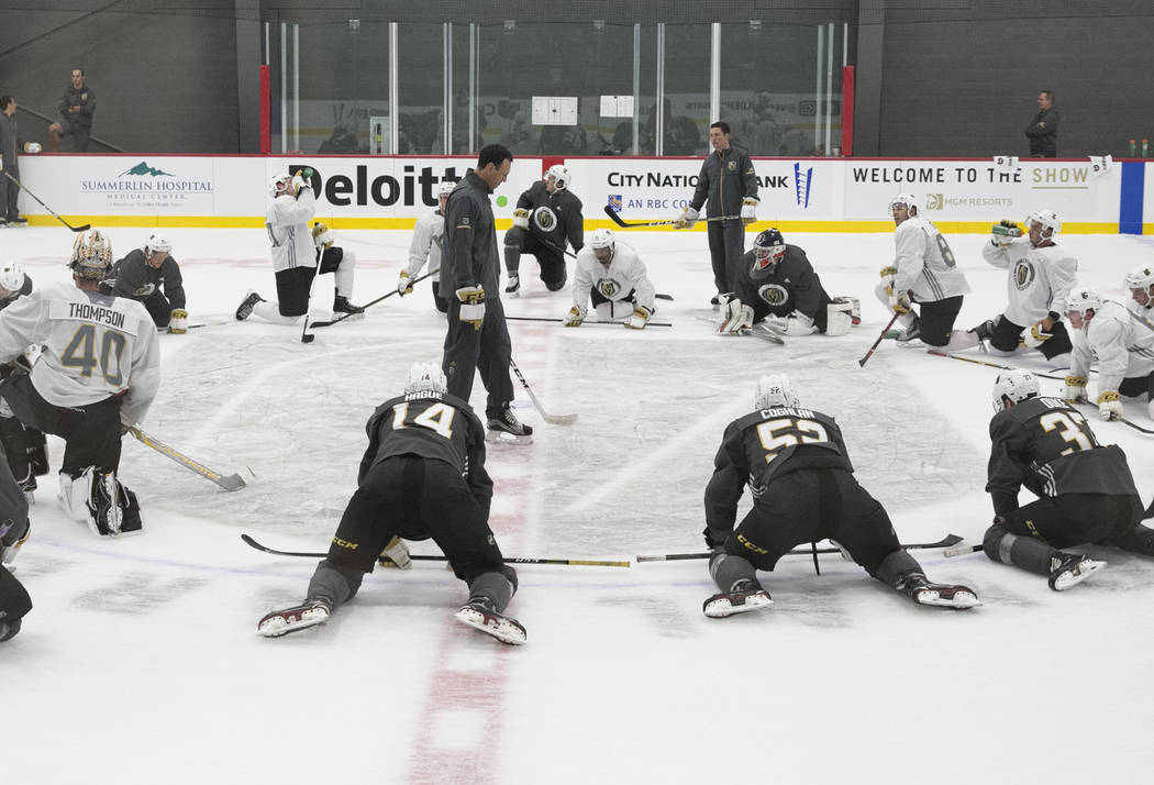 The Chicago Wolfs' coach Rocky Thompson, center, watches as the Vegas Golden Knights' players s ...