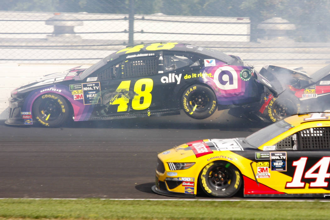 NASCAR driver Jimmie Johnson (48) is hit by Parker Kligerman (96) in the second turn during the ...