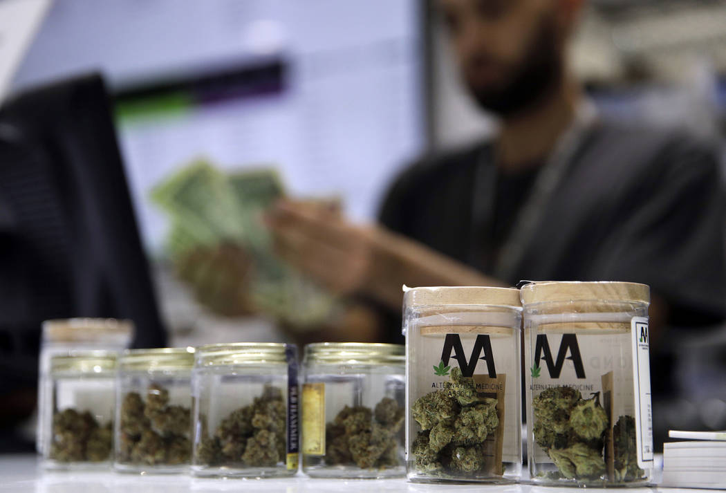 A cashier rings up a marijuana sale at the Essence cannabis dispensary in Las Vegas. (John Loch ...