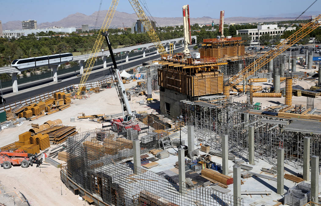 Las Vegas Monorail trains pass the under-construction MSG Sphere performance venue in Las Vegas ...