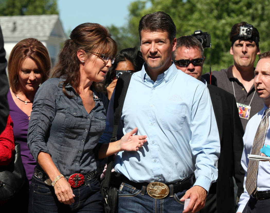 FILE - In this June 28, 2011, file photo, Sarah and Todd Palin make their way to the Pella Oper ...