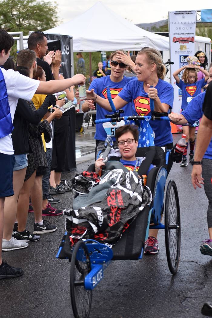 Race participants cross the finish line at a past Superhero 5K. This year's Candlelighters fund ...