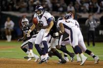 Denver Broncos quarterback Joe Flacco is sacked by Oakland Raiders defensive end Benson Mayowa ...