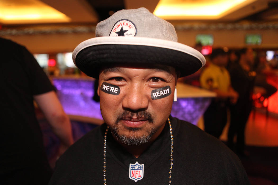 Victor Tayang wears his Oakland Raider gear before the Raiders first game of the season against ...