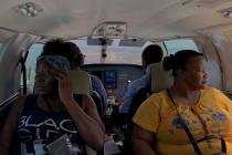 Dimple Lightbourne, left, and her mother Carla Ferguson sit in a plane as it approaches to land ...