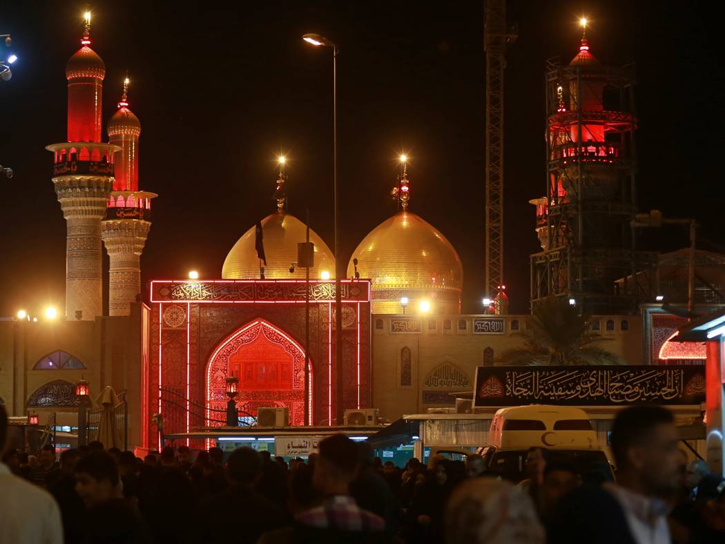 Shiite Muslims gather outside the golden-domed shrine of Imam Moussa al-Kadhim during a Muharra ...