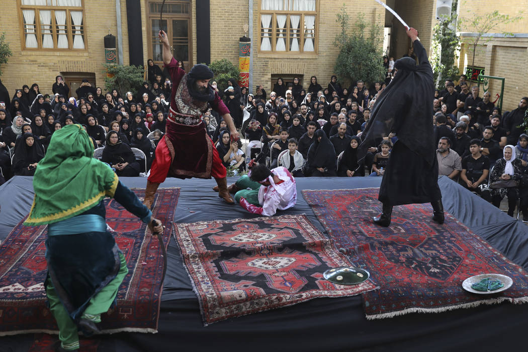 Actors perform Tazieh, a traditional play re-enacting the death of Hussein, the grandson of Pro ...