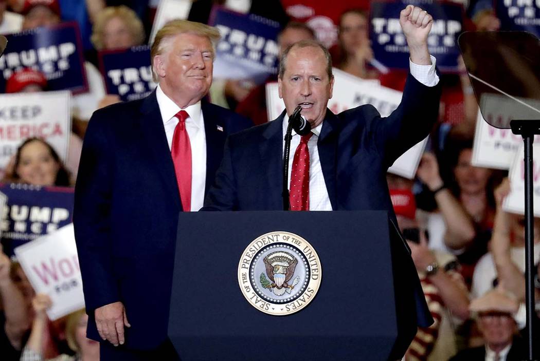 President Donald Trump, left, gives his support to Dan Bishop, right, a Republican running for ...