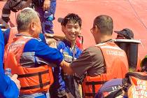 In this image released by the U.S. Coast Guard shows a crew member of the cargo ship Golden Ray ...
