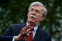 National security adviser John Bolton talks to reporters outside the White House in Washington, ...