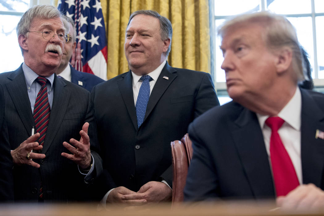 National Security Adviser John Bolton, left, with by Secretary of State Mike Pompeo, stand behi ...