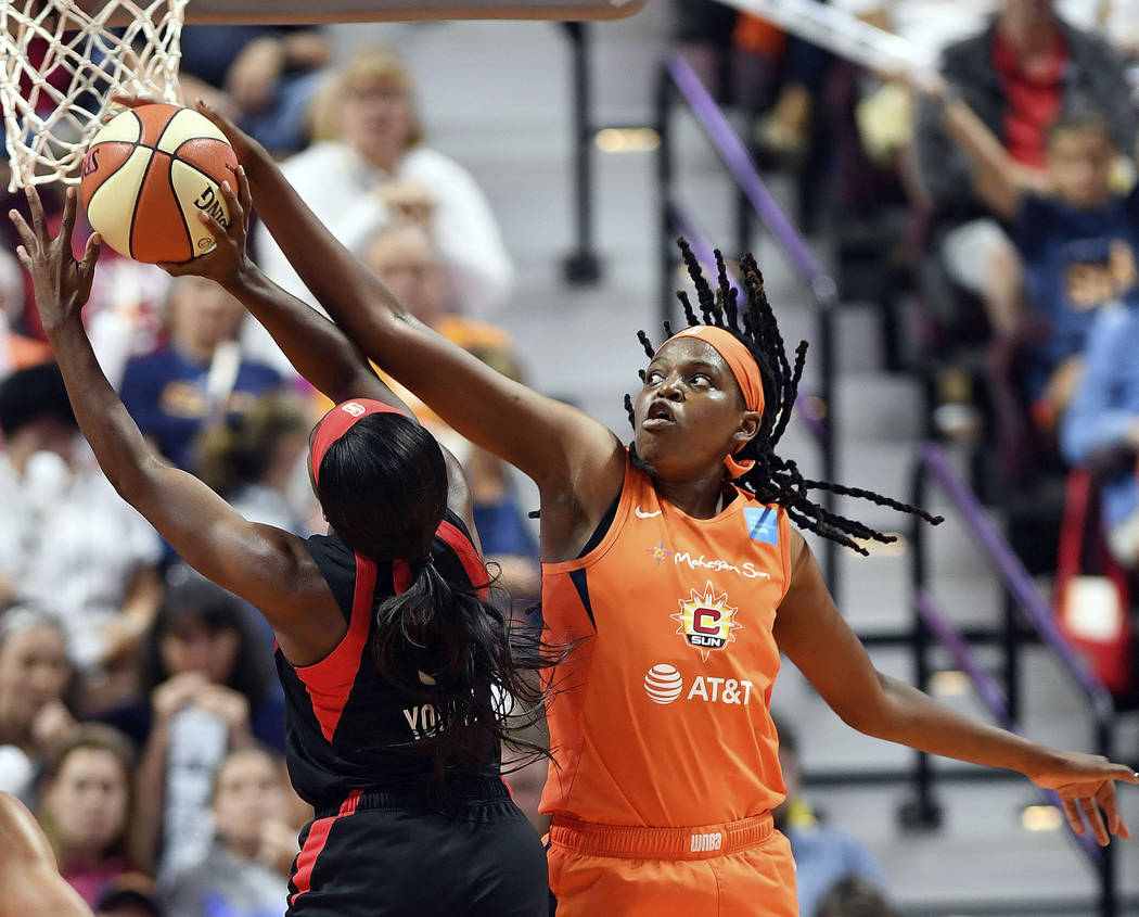 Connecticut Sun center Jonquel Jones blocks a shot attempt from Las Vegas Aces guard Jackie You ...