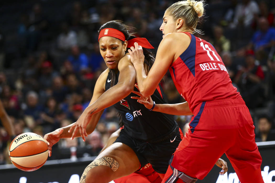 Las Vegas Aces center A'ja Wilson (22) moves the ball around Washington Mystics forward Elena D ...