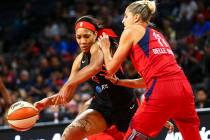 Las Vegas Aces center A'ja Wilson (22) moves the ball around Washington Mystics forward Elena D ...