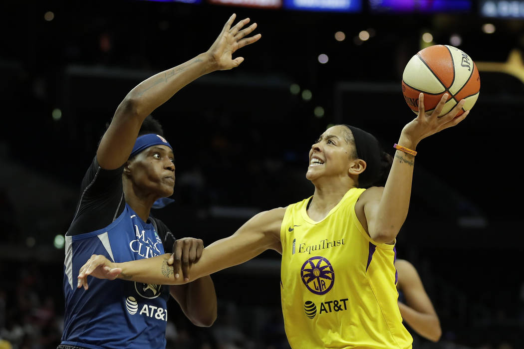 Minnesota Lynx center Sylvia Fowles, left, fouls Los Angeles Sparks forward Candace Parker duri ...