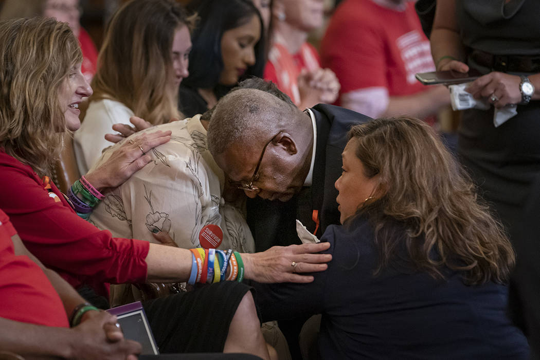 Pastor Jackie Jackson, center, an anti-violence advocate from Cincinnati, is joined by gun viol ...