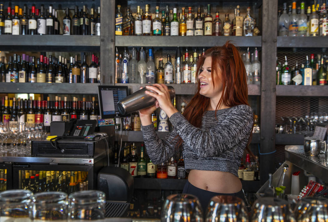 Bartender Alexandria Spina prepares a cocktail at Grape Street Café, Wine Bar & Cellar in Down ...