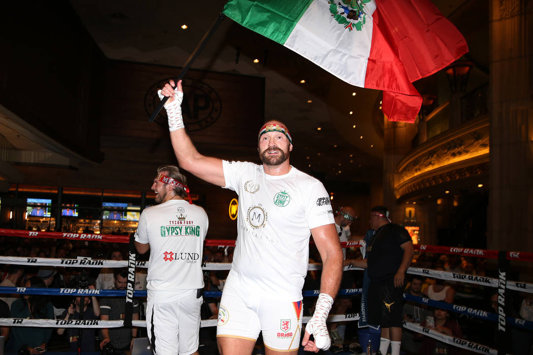 Heavyweight fighter Tyson Fury waves a Mexican flag during his open workout at the MGM Grand ho ...