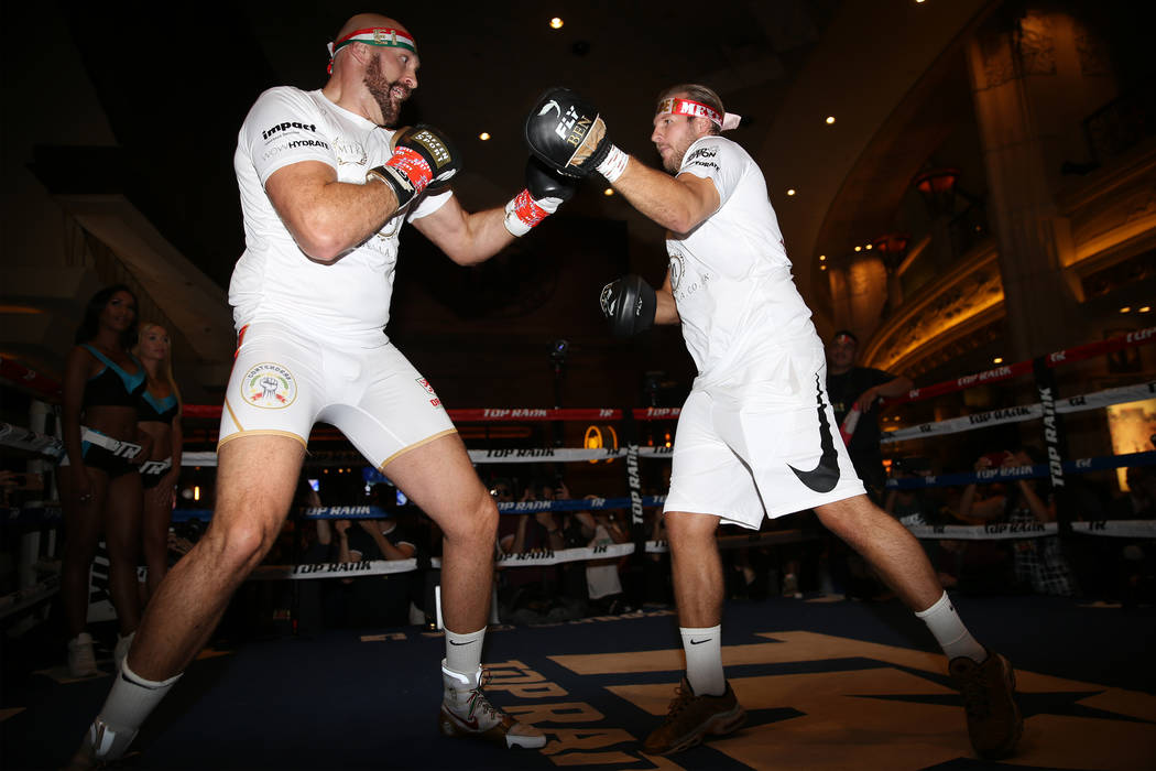 Heavyweight fighter Tyson Fury, left, with trainer Ben Davison, during an open workout at the M ...