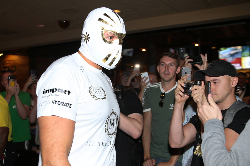 Heavyweight fighter Tyson Fury makes his way to the ring wearing a Mexican wrestling mask for a ...
