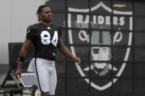 Oakland Raiders' Antonio Brown walks on the field while stretching during NFL football practice ...