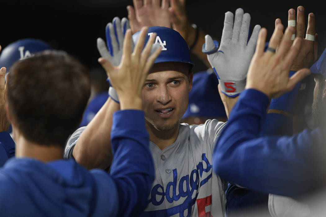 Los Angeles Dodgers' Corey Seager is congratulated in the dugout for his three-run home run dur ...