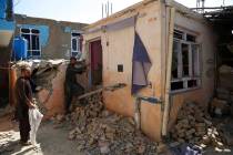 In a Tuesday, Sept. 10, 2019, photo, Afghans inspect their damaged house after a large explosio ...