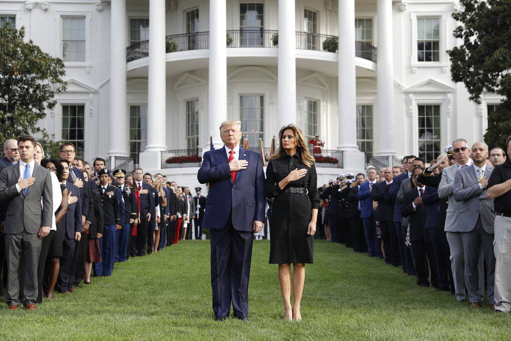 President Donald Trump and first lady Melania Trump participate in a moment of silence honoring ...