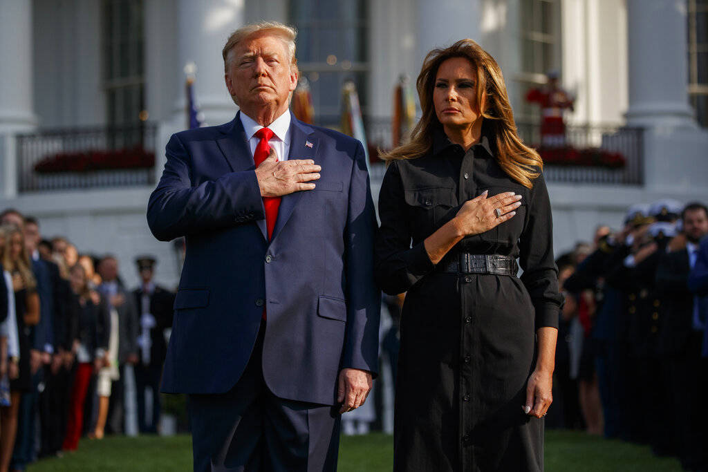 President Donald Trump and first lady Melania Trump participate in a moment of silence honoring ...