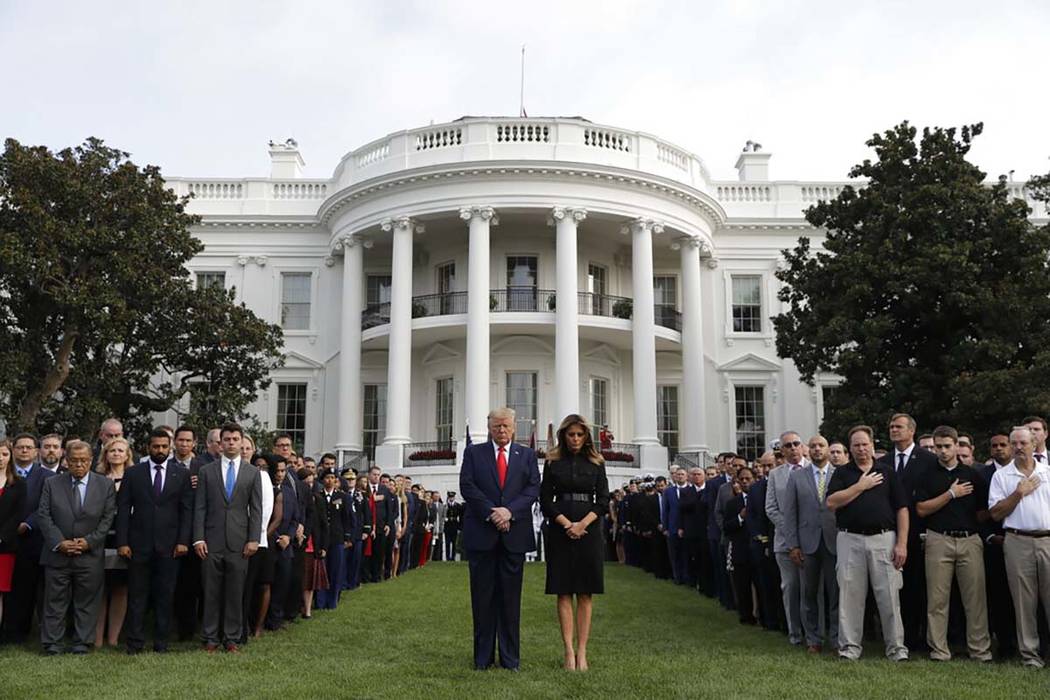 President Donald Trump and first lady Melania Trump participate in a moment of silence honoring ...