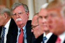 In an April 18, 2018, file photo, National security adviser John Bolton, left, listens to Presi ...