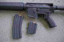 In this April 10, 2013, file photo, a stag arms AR-15 rifle with 30 round, left, and 10 round m ...