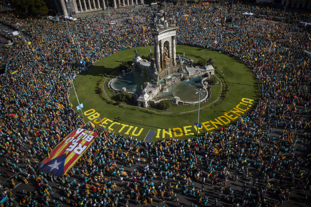 Protesters hold esteladas or independence flags as they take part in a demonstration during the ...