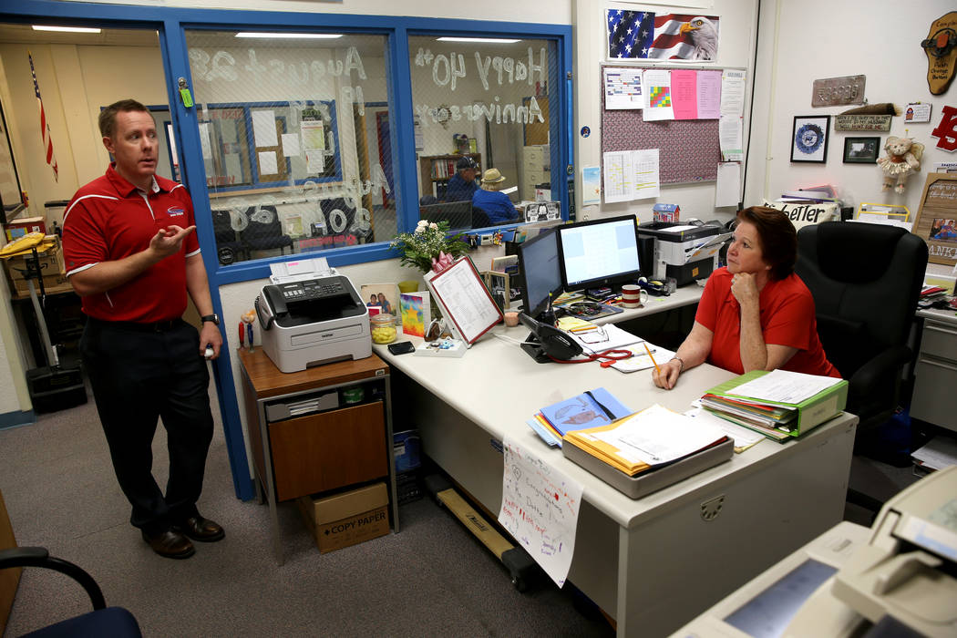 Dottie Frank, an administrative school secretary at Indian Springs School, talks to Principal D ...