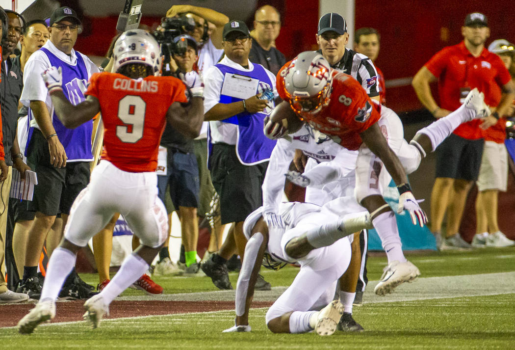 UNLV Rebels running back Charles Williams (8) is upended on a run over Southern Utah in the fir ...