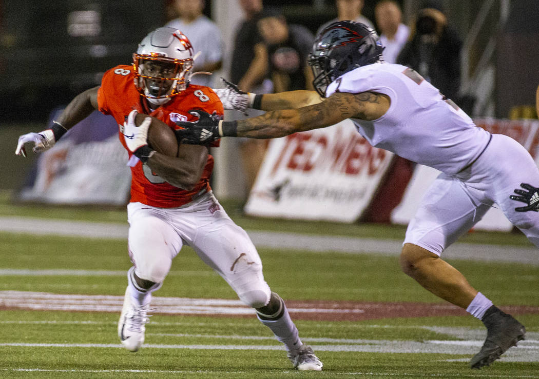 UNLV Rebels running back Charles Williams (8) looks to break a tackle attempt by Southern Utah ...
