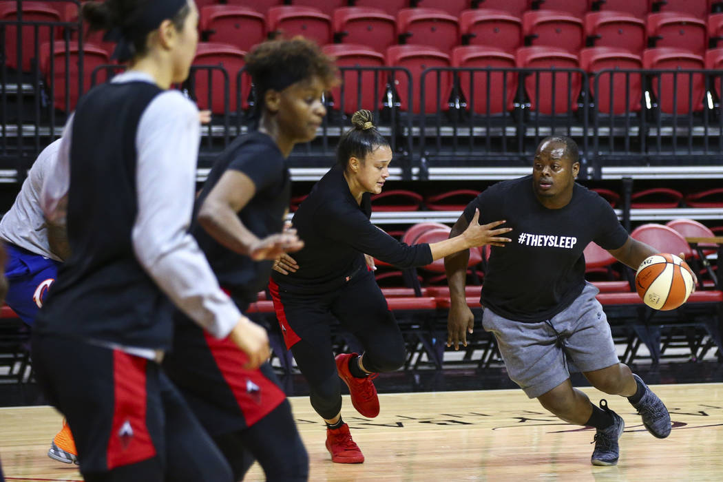 Dreu Johnson, right, drives the ball under pressure from Las Vegas Aces' Kayla McBride during p ...